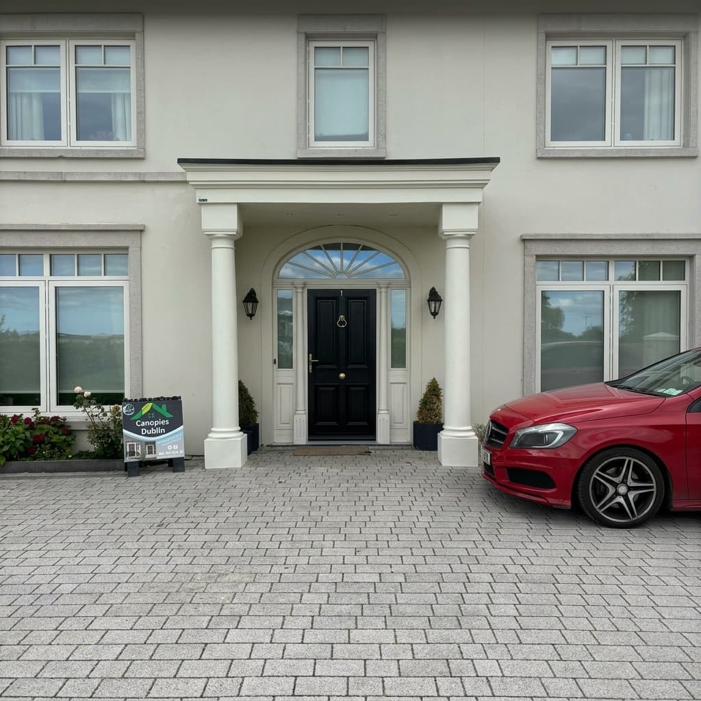 Large portico canopy with round columns and arched doorway on detached residence