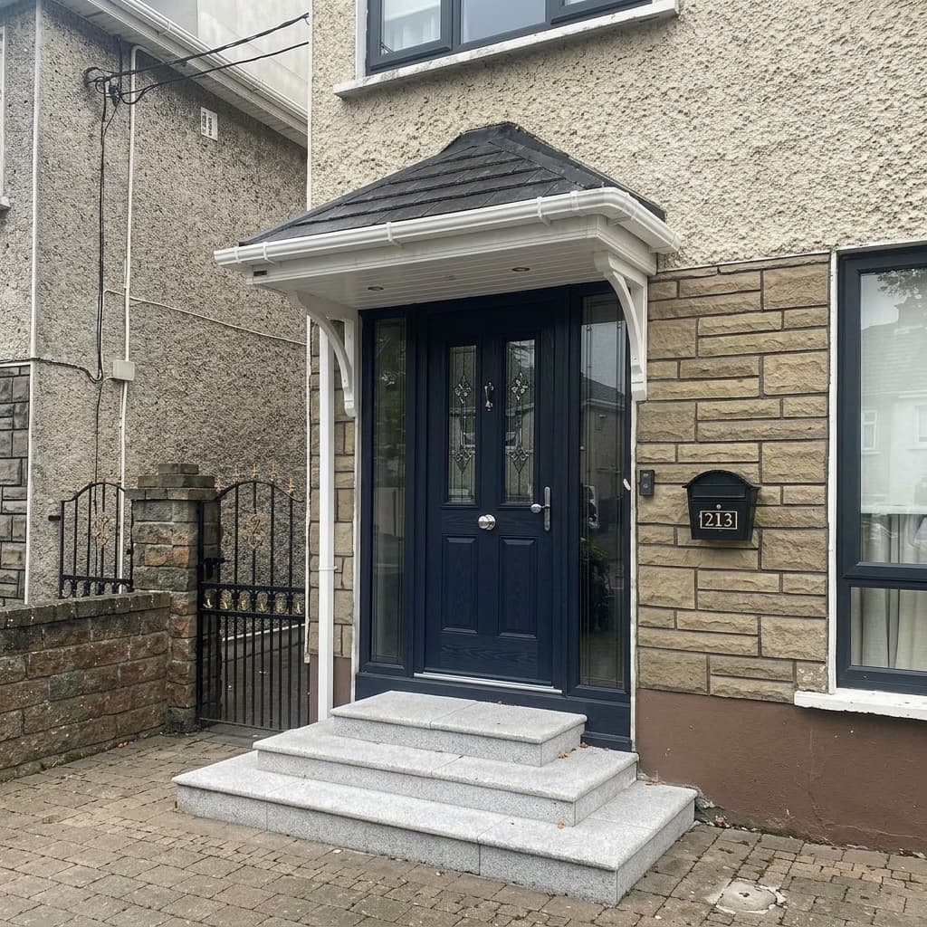 Hipped canopy with white columns over blue door and stone steps